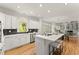 Kitchen featuring white cabinets, stainless steel appliances, an island with bar seating, and hardwood flooring at 3049 Brightwood Se Ln, Marietta, GA 30067