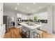 Bright kitchen features a center island with stool seating, white cabinets, and stainless steel appliances at 3049 Brightwood Se Ln, Marietta, GA 30067