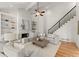Inviting living room with a fireplace, built-in shelving, and a staircase in an open-concept design at 3049 Brightwood Se Ln, Marietta, GA 30067