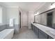 Elegant bathroom featuring a soaking tub, sleek vanity with double sinks, and modern tile flooring at 485 Discovery Lake Dr, Fayetteville, GA 30215