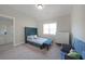 Cozy bedroom with a blue upholstered bed, a dresser, and a window with natural light at 485 Discovery Lake Dr, Fayetteville, GA 30215