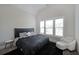 Comfortable bedroom with a large window, plush carpet, and a stylish bed frame at 485 Discovery Lake Dr, Fayetteville, GA 30215