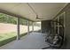 A covered outdoor patio featuring hanging chairs with a serene view of the backyard at 485 Discovery Lake Dr, Fayetteville, GA 30215