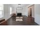 Spacious living room with dark hardwood floors, wainscotting, and ample natural light at 485 Discovery Lake Dr, Fayetteville, GA 30215