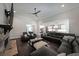 Inviting living room featuring a stone fireplace, dark wood floors, and seamless flow into the kitchen at 485 Discovery Lake Dr, Fayetteville, GA 30215