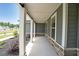 View of the covered porch with white pillars and stone accents at 485 Discovery Lake Dr, Fayetteville, GA 30215