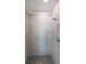Modern shower with gray tiled walls, a rainfall showerhead, and a mosaic tile floor at 485 Discovery Lake Dr, Fayetteville, GA 30215