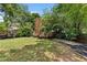 Large, green backyard featuring healthy grass and wood privacy fence at 5415 Fieldfreen Dr, Cumming, GA 30028