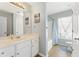 This bathroom has bright cabinets, a large mirror, and a tub/shower combo at 5415 Fieldfreen Dr, Cumming, GA 30028