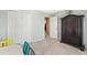 Inviting bedroom with table, closet, and large armoire at 5415 Fieldfreen Dr, Cumming, GA 30028