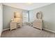Bright bedroom with neutral tones, featuring a vanity and ample natural light from the window at 5415 Fieldfreen Dr, Cumming, GA 30028