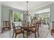 Inviting dining area with round table, seating for six, ample natural light, and a view into the office, perfect for gatherings at 5415 Fieldfreen Dr, Cumming, GA 30028