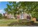 Inviting home with manicured lawn, stone accents, a two-car garage and mature trees, located in a desirable neighborhood at 5415 Fieldfreen Dr, Cumming, GA 30028