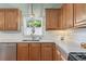 Bright kitchen with stainless dishwasher, plentiful wood cabinetry, and stylish white countertops at 5415 Fieldfreen Dr, Cumming, GA 30028