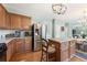 Spacious kitchen with wooden cabinets, a stainless-steel refrigerator, an island, and easy access to the dining area at 5415 Fieldfreen Dr, Cumming, GA 30028