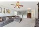 A large living space featuring ample seating, a ceiling fan, and lots of natural light at 5415 Fieldfreen Dr, Cumming, GA 30028
