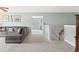 Relaxing living room with cozy gray sectional and stairway access at 5415 Fieldfreen Dr, Cumming, GA 30028