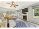 Comfortable living room with a fireplace, a ceiling fan, and plenty of natural light streaming through the windows at 5415 Fieldfreen Dr, Cumming, GA 30028