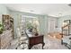 Sunlit office with a comfortable workspace, neutral colors, a bay window, and classic furnishings, creating an ideal work environment at 5415 Fieldfreen Dr, Cumming, GA 30028