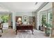 Bright home office featuring a large desk, built-in bookcases, and plenty of natural light, ideal for remote work at 5415 Fieldfreen Dr, Cumming, GA 30028