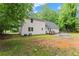 Expansive backyard featuring a new patio, a wood deck, a large lawn area, and mature trees for ample shade at 5902 Wills Orchard Rd, Cumming, GA 30040