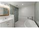 Bright bathroom featuring a soaking tub and a rain shower head at 5902 Wills Orchard Rd, Cumming, GA 30040