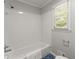 Full bathroom with white subway tile, modern fixtures, and a window for natural light at 5902 Wills Orchard Rd, Cumming, GA 30040