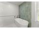 Bright bathroom featuring a modern soaking tub and stylish green tile at 5902 Wills Orchard Rd, Cumming, GA 30040