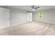 Large primary bedroom with carpet, a sliding barn door, and a window for natural light at 5902 Wills Orchard Rd, Cumming, GA 30040