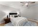 This bedroom features a ceiling fan and a window for natural light at 5902 Wills Orchard Rd, Cumming, GA 30040