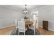 Elegant dining room with a round wooden table, stylish chairs, and natural light at 5902 Wills Orchard Rd, Cumming, GA 30040
