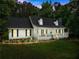 Charming one-story home featuring a welcoming front porch, a well-manicured lawn and beautiful surrounding trees at 5902 Wills Orchard Rd, Cumming, GA 30040