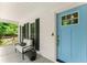 Inviting front porch with comfortable seating area next to a charming light-blue front door at 5902 Wills Orchard Rd, Cumming, GA 30040