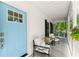 Inviting front porch featuring a comfortable seating area and a charming blue front door at 5902 Wills Orchard Rd, Cumming, GA 30040