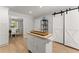 Charming kitchen with a functional island and hardwood floors at 5902 Wills Orchard Rd, Cumming, GA 30040