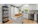 Bright kitchen with white cabinets, a functional island, and sliding barn doors at 5902 Wills Orchard Rd, Cumming, GA 30040