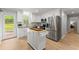 Modern kitchen with white cabinets, stainless steel appliances, and an island at 5902 Wills Orchard Rd, Cumming, GA 30040