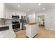 Well-equipped kitchen with white cabinetry, stainless appliances, and a kitchen island at 5902 Wills Orchard Rd, Cumming, GA 30040