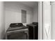 This laundry room includes a new washer and dryer, with a sliding barn door for privacy at 5902 Wills Orchard Rd, Cumming, GA 30040