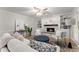 Comfortable living room with a fireplace, built-in shelving, and natural light at 5902 Wills Orchard Rd, Cumming, GA 30040