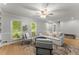 Bright living room with large windows, plush seating, and hardwood floors at 5902 Wills Orchard Rd, Cumming, GA 30040