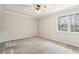 Neutral bedroom with a ceiling fan and a bright window at 6806 Glenridge Dr # E, Atlanta, GA 30328