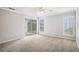 Light-filled bedroom with sliding glass doors leading to outdoor patio at 6806 Glenridge Dr # E, Atlanta, GA 30328