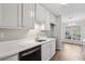 Galley kitchen with white cabinets, quartz countertops and black appliances at 6806 Glenridge Dr # E, Atlanta, GA 30328