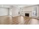 Spacious living room featuring hardwood floors, fireplace, and abundant natural light at 6806 Glenridge Dr # E, Atlanta, GA 30328