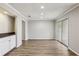 Open living room with hardwood floors, recessed lighting and sliding glass door at 6806 Glenridge Dr # E, Atlanta, GA 30328