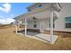A covered back porch of a two-story house, perfect for entertaining or relaxing outdoors at 1246 Allspice Way, Lawrenceville, GA 30045