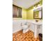 Charming bathroom featuring a pedestal sink, unique brick flooring, and decorative wall accents at 1384 Independence Way, Marietta, GA 30062