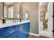 Modern bathroom with blue vanity, gold hardware, and tiled floors with a separate toilet room at 1384 Independence Way, Marietta, GA 30062
