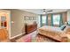 Comfortable bedroom featuring hardwood floors, ceiling fan, and a large area rug at 1384 Independence Way, Marietta, GA 30062
